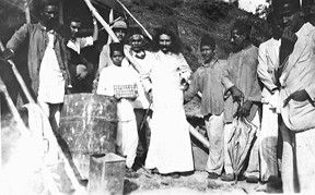 With workers holding tools at a construction site.