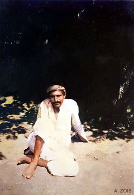 Poona, India. Meher Baba relaxing outside his thatched hut.