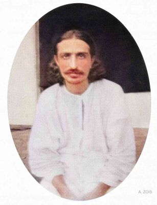 Seated portrait in white kurta.