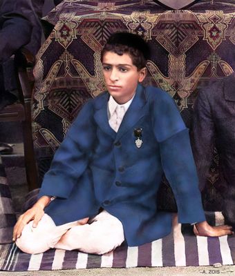Merwan Irani seated with the St. Vincent's cricket team holding the winner's trophy.