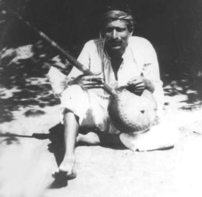 Meher Baba with a banjo.
